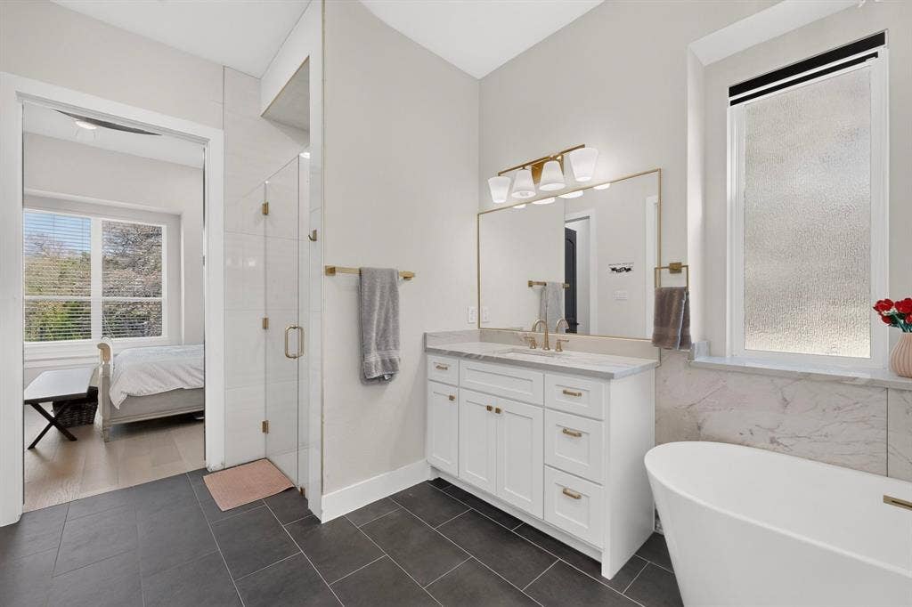 2519 Tamaron Cove, Cedar Hill, TX 75104 White vanity with gold-tone hardware, undermount sink, and marble countertop