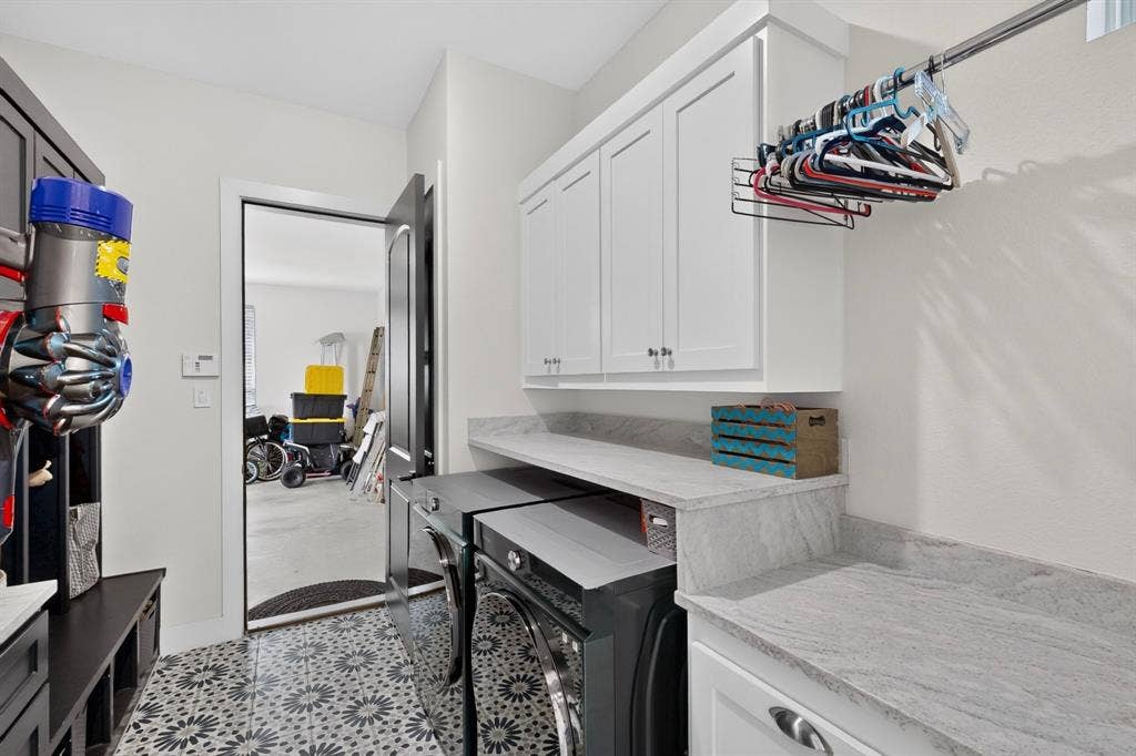 2519 Tamaron Cove, Cedar Hill, TX 75104 Geometric-patterned floor tile, white shaker-style cabinetry, light-toned countertop, and a clothes hanging rod