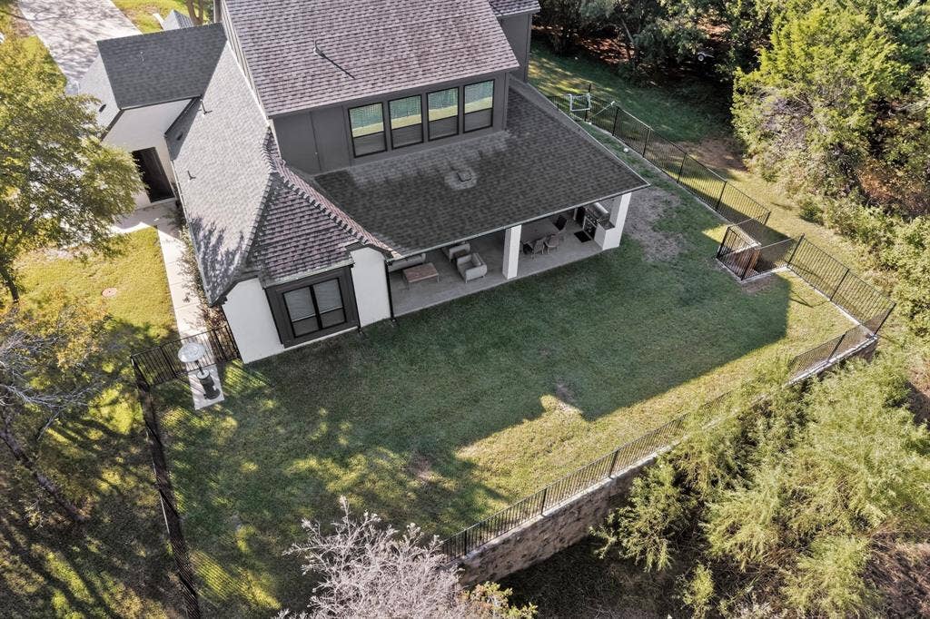 2519 Tamaron Cove, Cedar Hill, TX 75104 Two-story exterior with a covered patio, a manicured lawn, and a black wrought iron fence