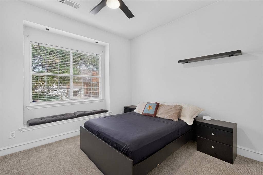 4237 McAlice Drive, Plano, TX 75093 Recessed window with built-in seating, modern ceiling fan, and wall-mounted shelving