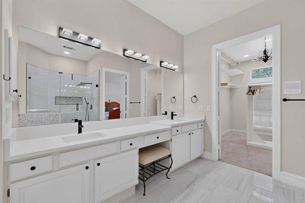 4237 McAlice Drive, Plano, TX 75093 Dual vanity with white cabinetry, integrated sinks, and quartz countertops