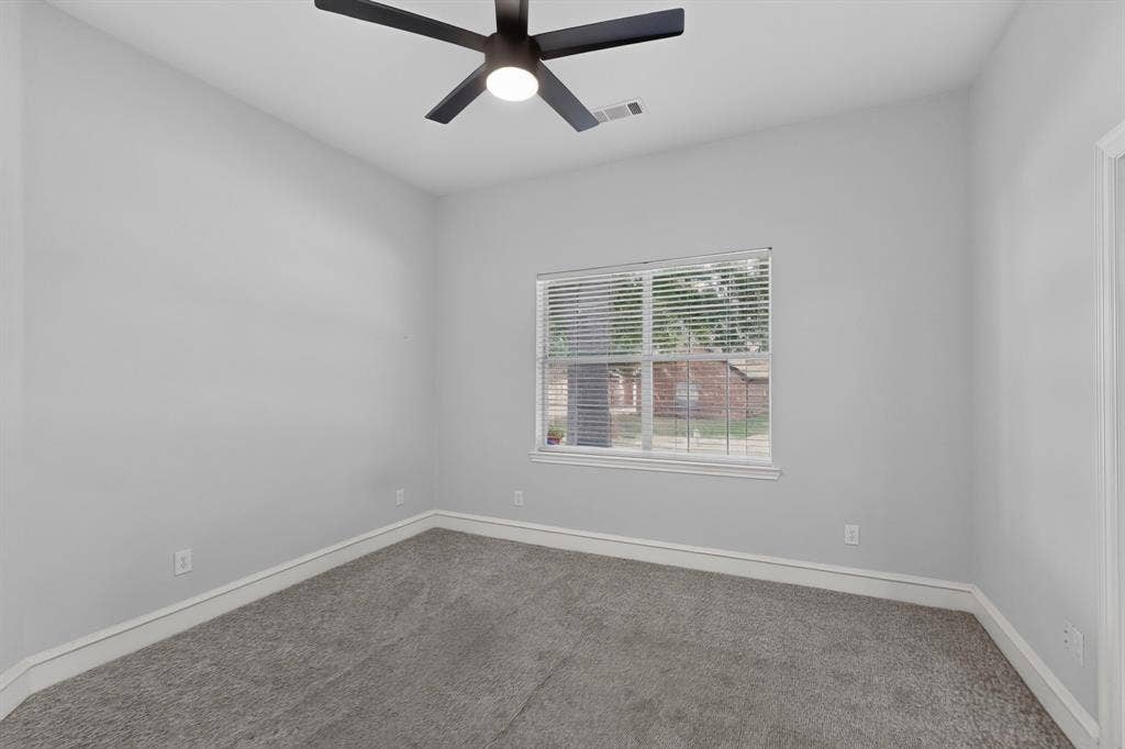 4237 McAlice Drive, Plano, TX 75093 Neutral gray wall paint, gray carpeting, white trim, window with blinds, and a ceiling fan with integrated lighting