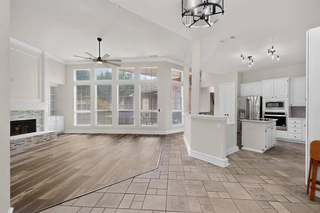 4237 McAlice Drive, Plano, TX 75093 Bright, open-concept living space with abundant natural light from expansive multi-pane glass doors and windows
