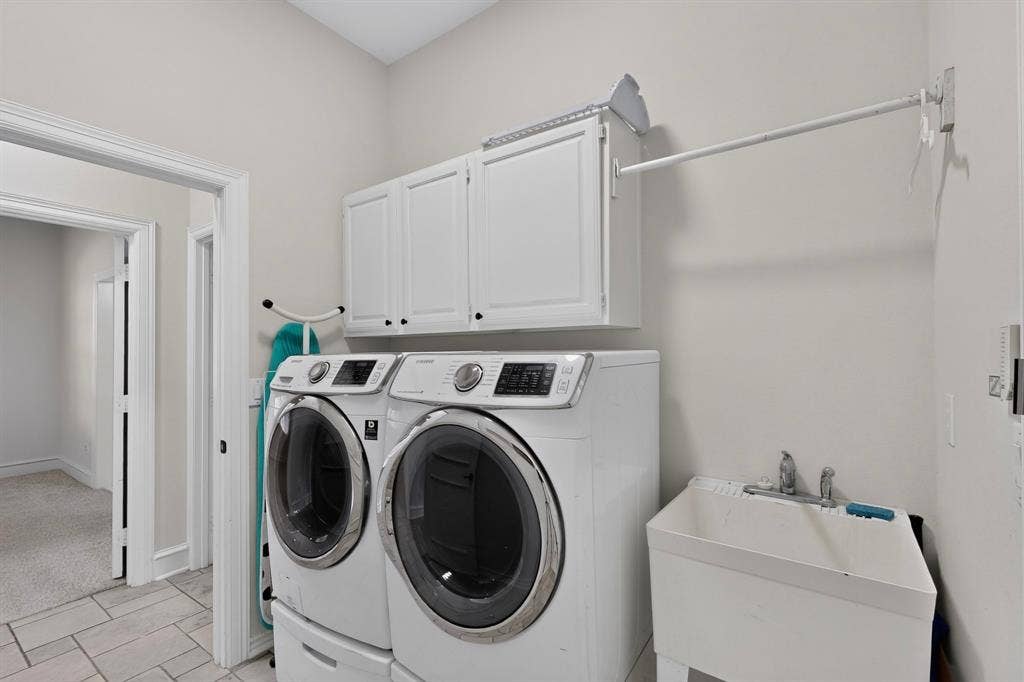4237 McAlice Drive, Plano, TX 75093 Utility room featuring white cabinetry, a laundry sink, and tile flooring