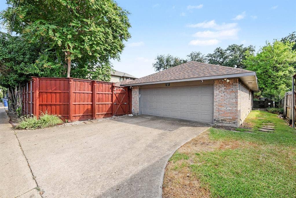 6503 Barfield Drive, Dallas, TX 75252 Attached two-car garage with brick veneer and composite shingle roof