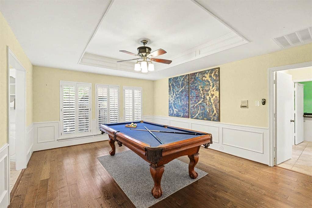 6503 Barfield Drive, Dallas, TX 75252 Hardwood flooring, recessed ceiling with fan, wainscoting, and white plantation shutters