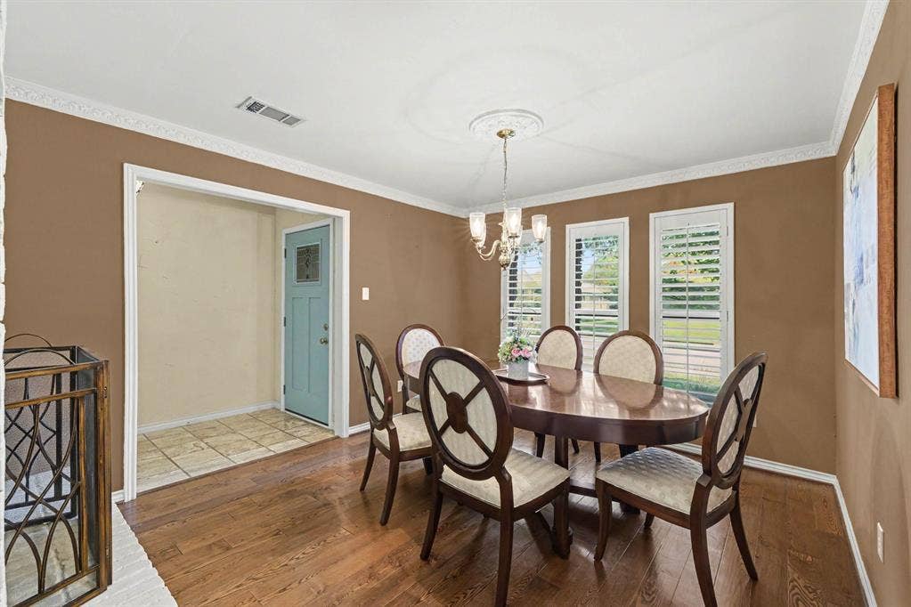 6503 Barfield Drive, Dallas, TX 75252 Hardwood flooring, crown molding, and a chandelier with a ceiling medallion