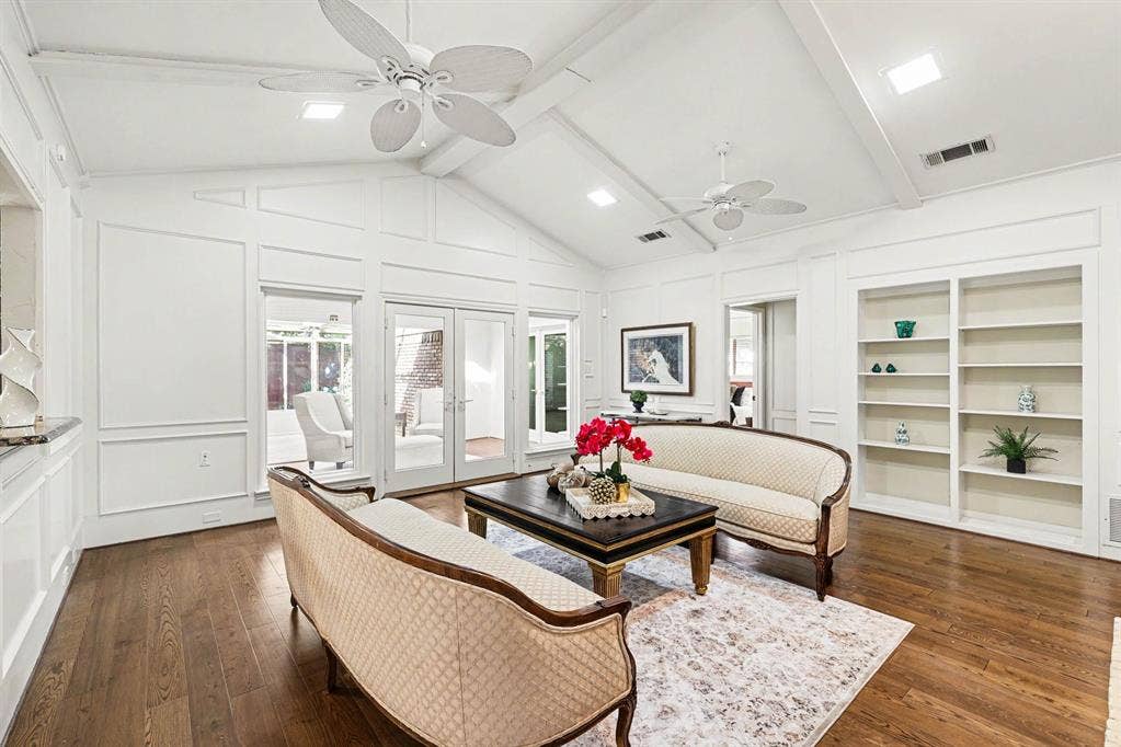 6503 Barfield Drive, Dallas, TX 75252 Vaulted ceiling with exposed beams, wood-finish flooring, built-in shelving, panel molding, and French doors
