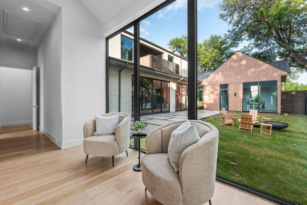 4103 Saranac Drive, Dallas, TX 75220 Expansive glass blurs the line between indoors and out, offering a true indoor-outdoor living experience from the privacy of the primary suite.