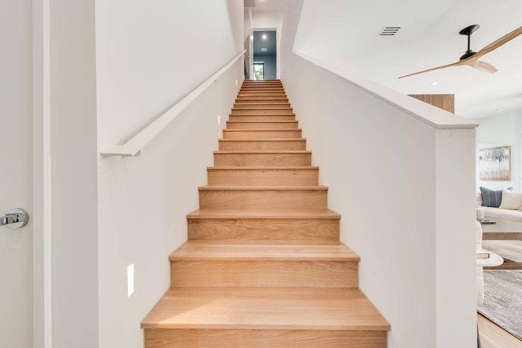 4103 Saranac Drive, Dallas, TX 75220 White oak stairs gracefully leading to the second floor, fitness room, second laundry "The treehouse" balcony and guest bedrooms