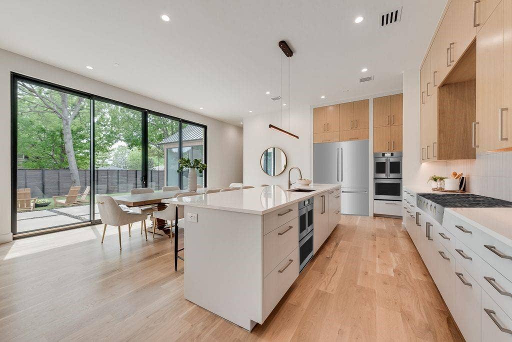 4103 Saranac Drive, Dallas, TX 75220 The modern kitchen is centered around an oversized island with uninterrupted views of the backyard.