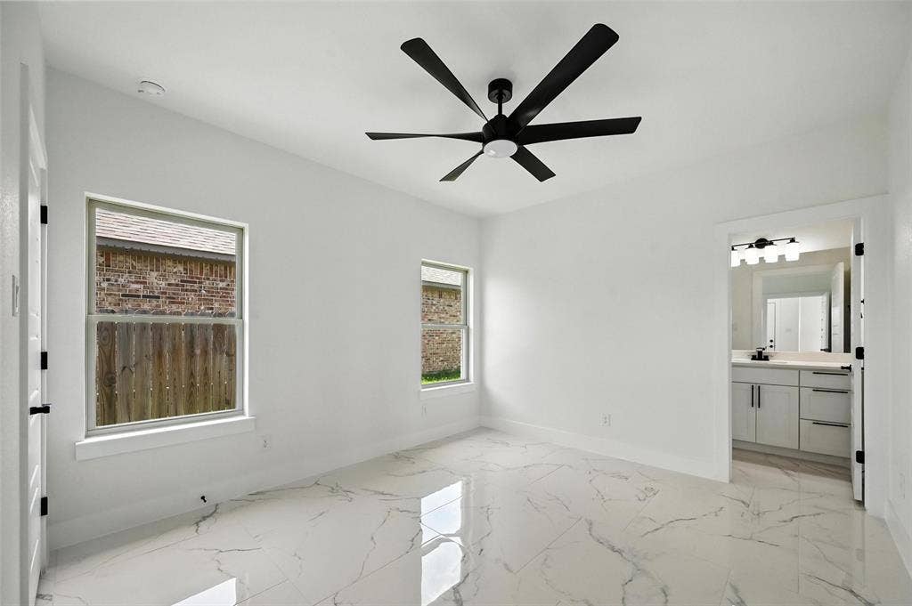 White walls with two pane windows and a contemporary black ceiling fan