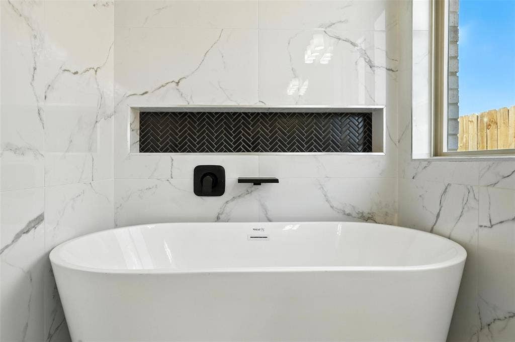 Freestanding soaking tub with matte black fixtures