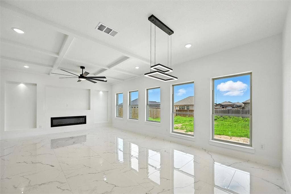 Coffered ceiling with recessed lighting and a ceiling fan