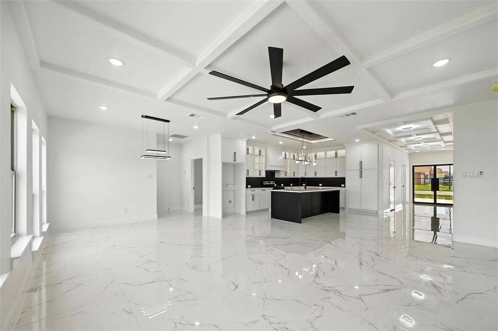 Coffered ceilings, recessed lighting, large format tile flooring, contemporary ceiling fan, and built-in kitchen cabinetry