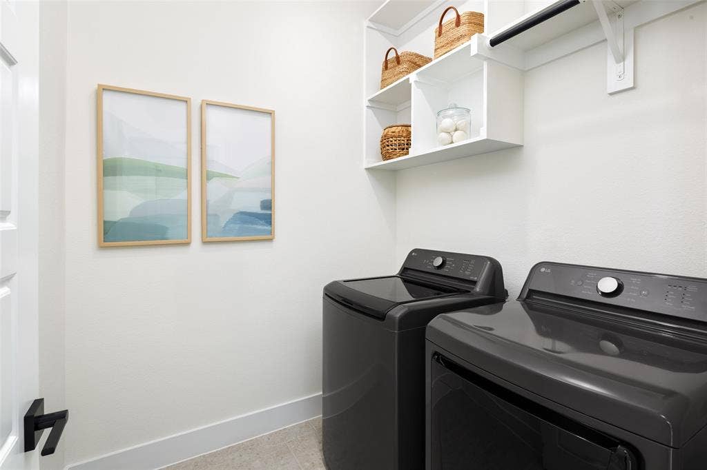 Laundry area featuring a top-load washer, front-load dryer, built-in shelving, and a hanging rod