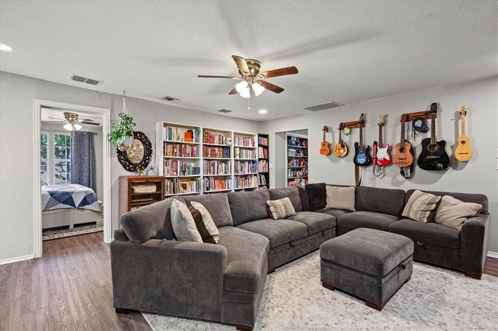 809 W Bridge Street, Weatherford, TX 76086 Built-in shelving, wood-finish flooring, recessed lighting, and ceiling fan