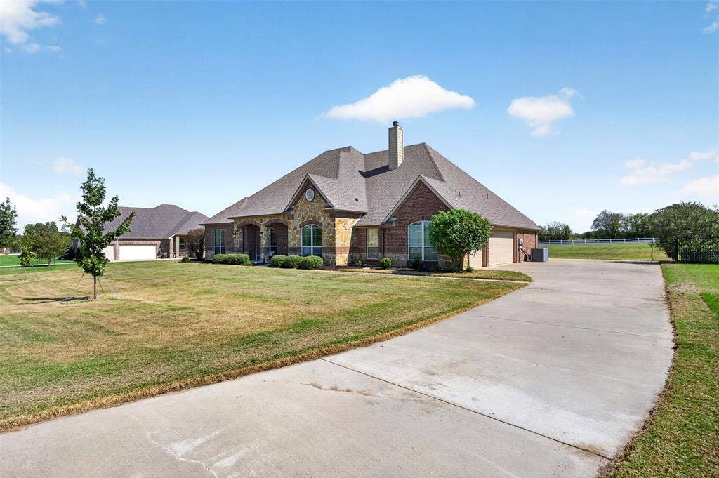 225 Diamond Rose Drive, Burleson, TX 76028 2015 single-story brick and stone home on 1.01 acres