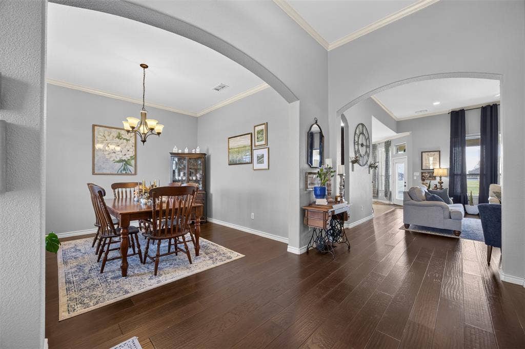225 Diamond Rose Drive, Burleson, TX 76028 Dark wood-finish flooring throughout, framed arched doorways, recessed lighting, and crown molding