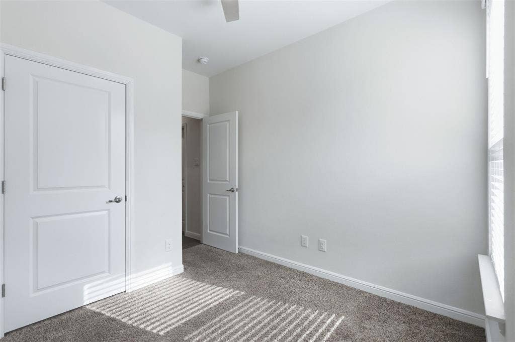 9005 Fescue Drive, Fort Worth, TX 76179 Neutral wall paint with carpet flooring, a ceiling fan, and white doors