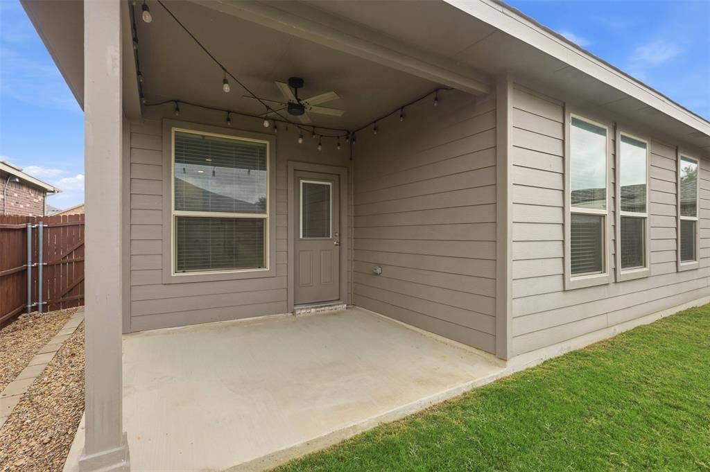 9005 Fescue Drive, Fort Worth, TX 76179 Covered patio with concrete flooring, equipped with a ceiling fan and string lighting