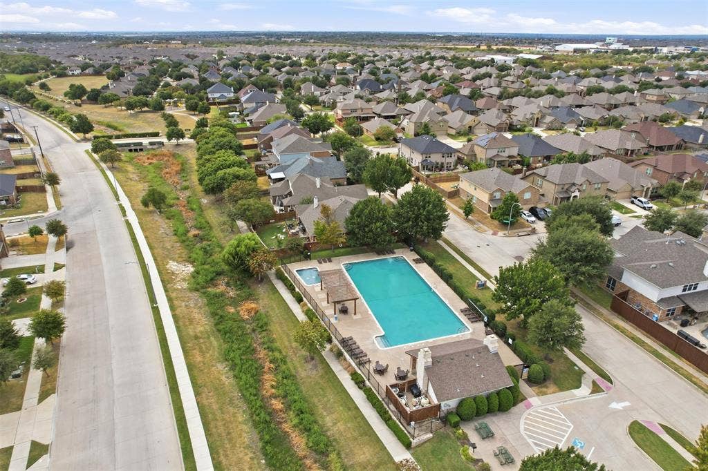 9005 Fescue Drive, Fort Worth, TX 76179 Community pool, spa, and amenity building with paved pool deck, shaded lounge areas, and perimeter fencing