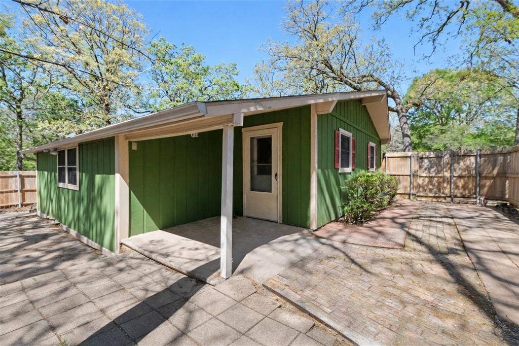 125 Harrell Street, Gun Barrel City, TX 75156 Private gated walkway and entrance to guest house features 2 bedrooms, 1 full bath, full kitchen, laundry and one car garage.