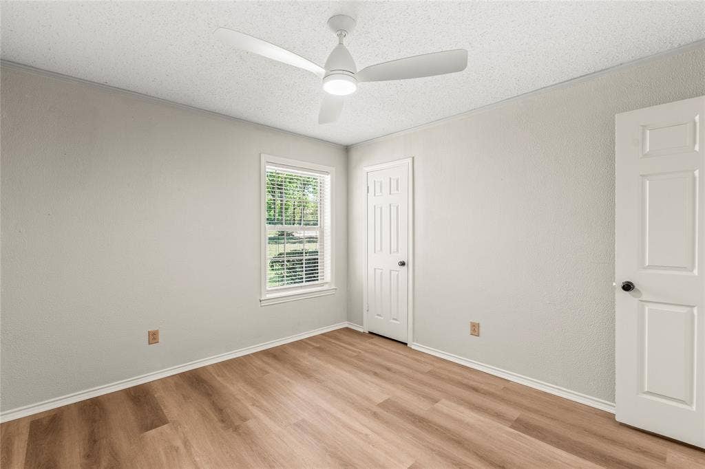 125 Harrell Street, Gun Barrel City, TX 75156 Primary en suite Bedroom freshly painted with new ceiling fan, luxury vinyl plank flooring.