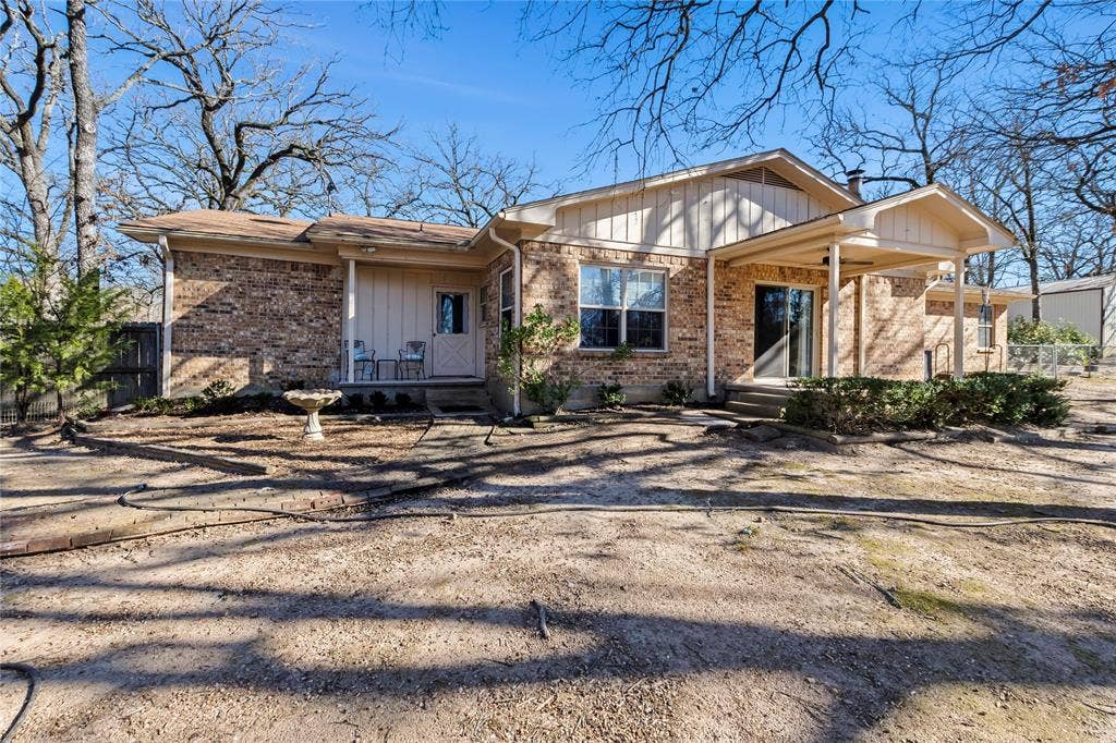 125 Harrell Street, Gun Barrel City, TX 75156 Covered back porch overlooks fenced yard and large pond on a total of 2.9 fenced acres--gorgeous trees!