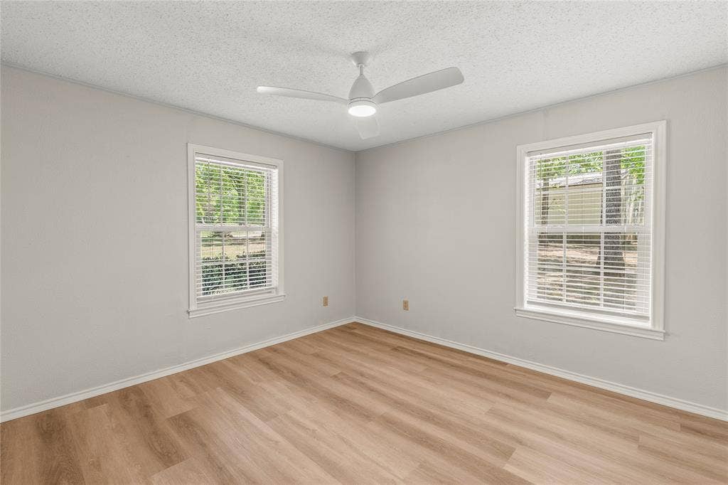 125 Harrell Street, Gun Barrel City, TX 75156 Bedroom 2 with new ceiling fan, luxury vinyl plank flooring.