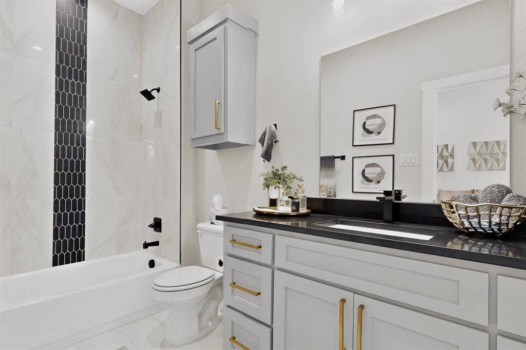 518 Crete Street, Dallas, TX 75203 White bathtub with black matte fixtures and a black picket tile accent