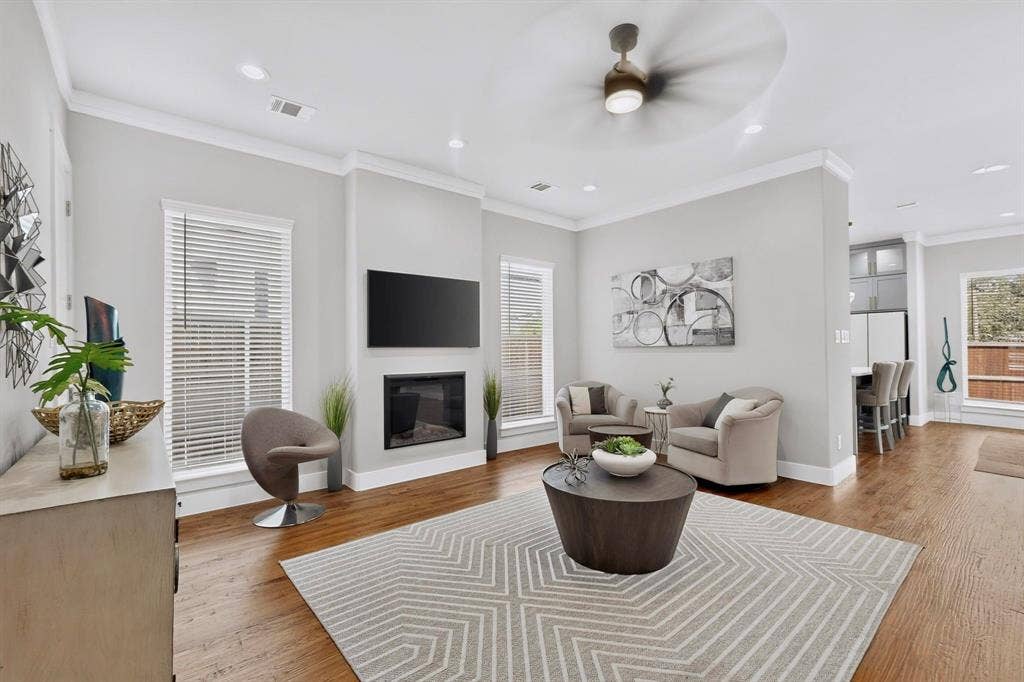518 Crete Street, Dallas, TX 75203 Wood-finish flooring with recessed lighting, crown molding, and a built-in fireplace