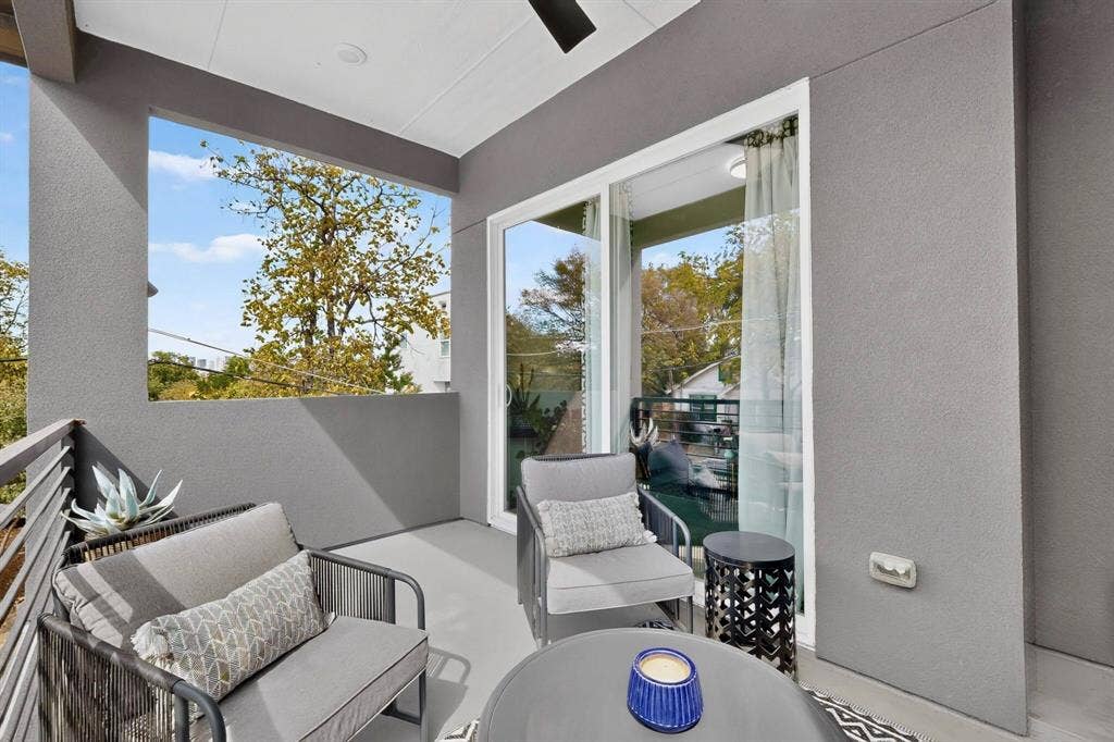 518 Crete Street, Dallas, TX 75203 Balcony featuring a ceiling fan, sliding glass doors, metal railings, and a smooth stucco finish