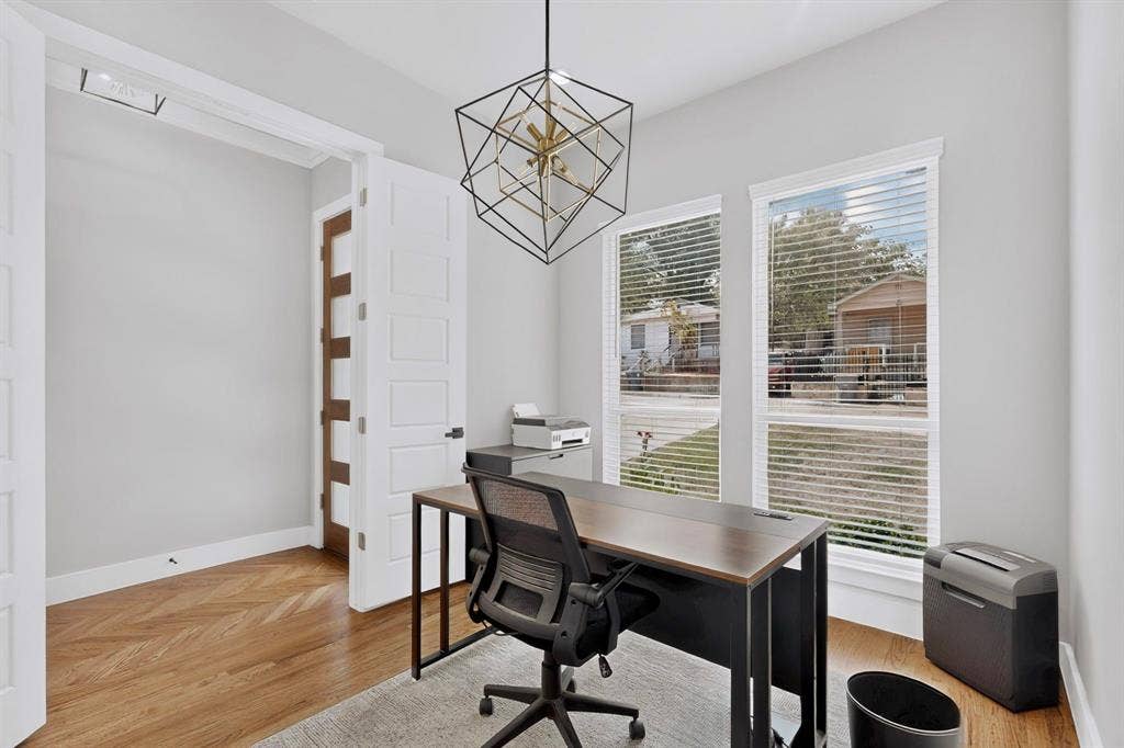 518 Crete Street, Dallas, TX 75203 Herringbone wood-finish flooring, two window openings, recessed lighting, and a modern geometric pendant light fixture