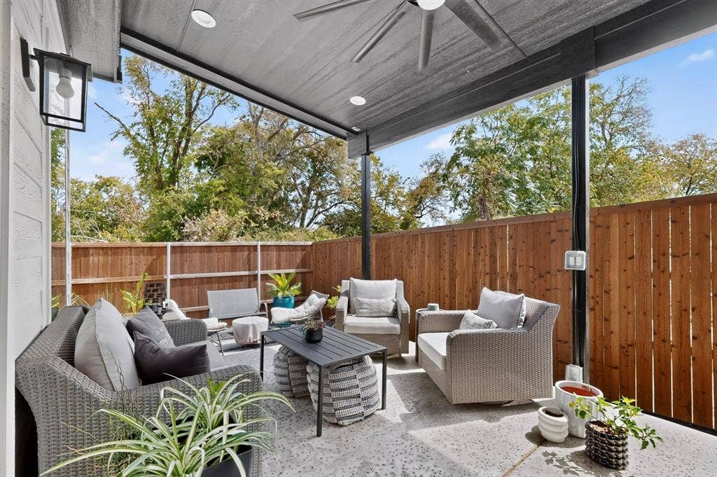 518 Crete Street, Dallas, TX 75203 Covered patio with concrete flooring, wood privacy fencing, and an exterior wall lantern