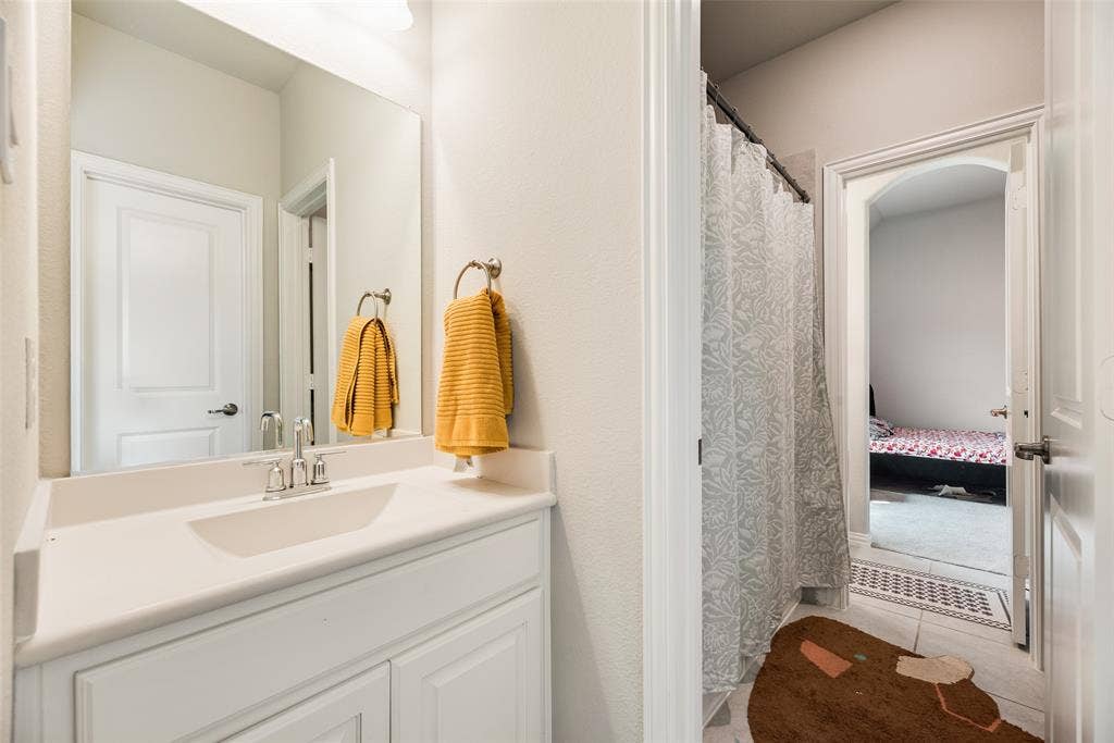718 Waterbrook Parkway, Argyle, TX 76226 White vanity with shaker-style cabinetry, an integrated sink, and a chrome faucet