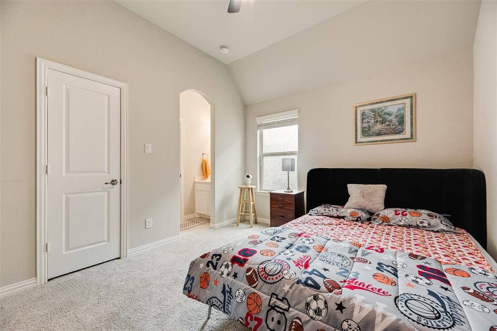 718 Waterbrook Parkway, Argyle, TX 76226 Vaulted ceiling, arched doorway, window with blinds, panel interior door, and light-colored carpeting