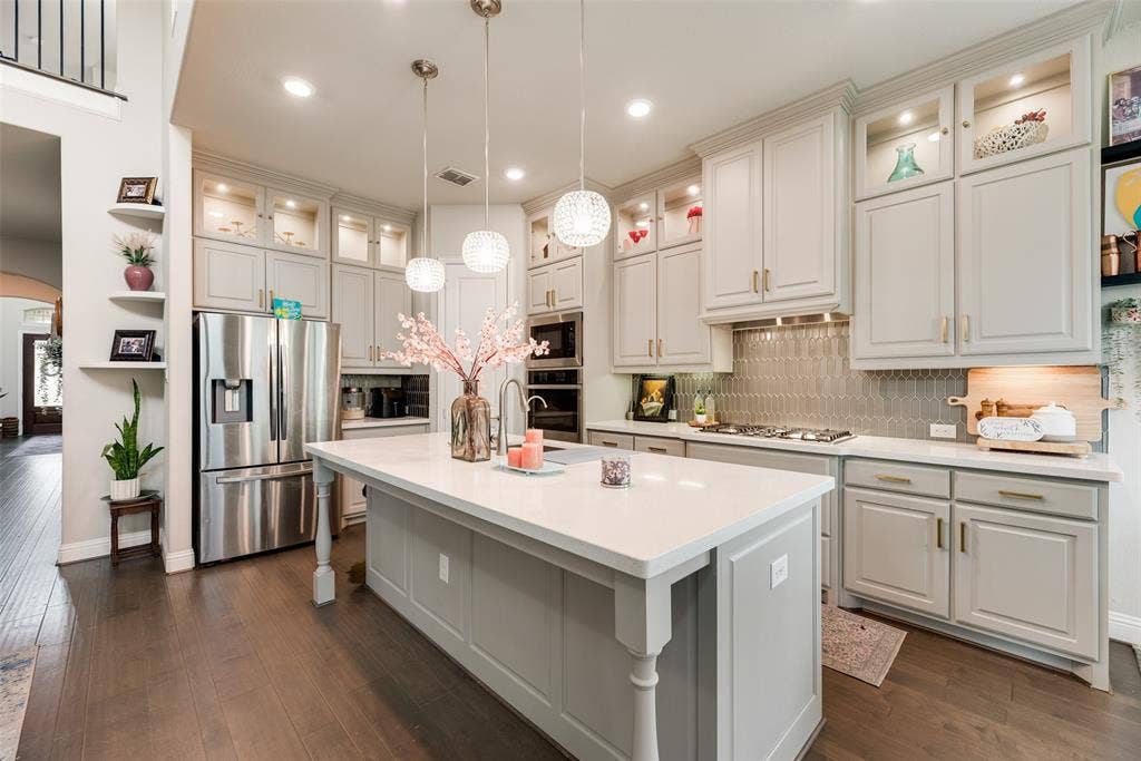 718 Waterbrook Parkway, Argyle, TX 76226 Kitchen featuring a large island, wood-finish flooring, recessed lighting, light-toned cabinetry, and stainless steel appliances
