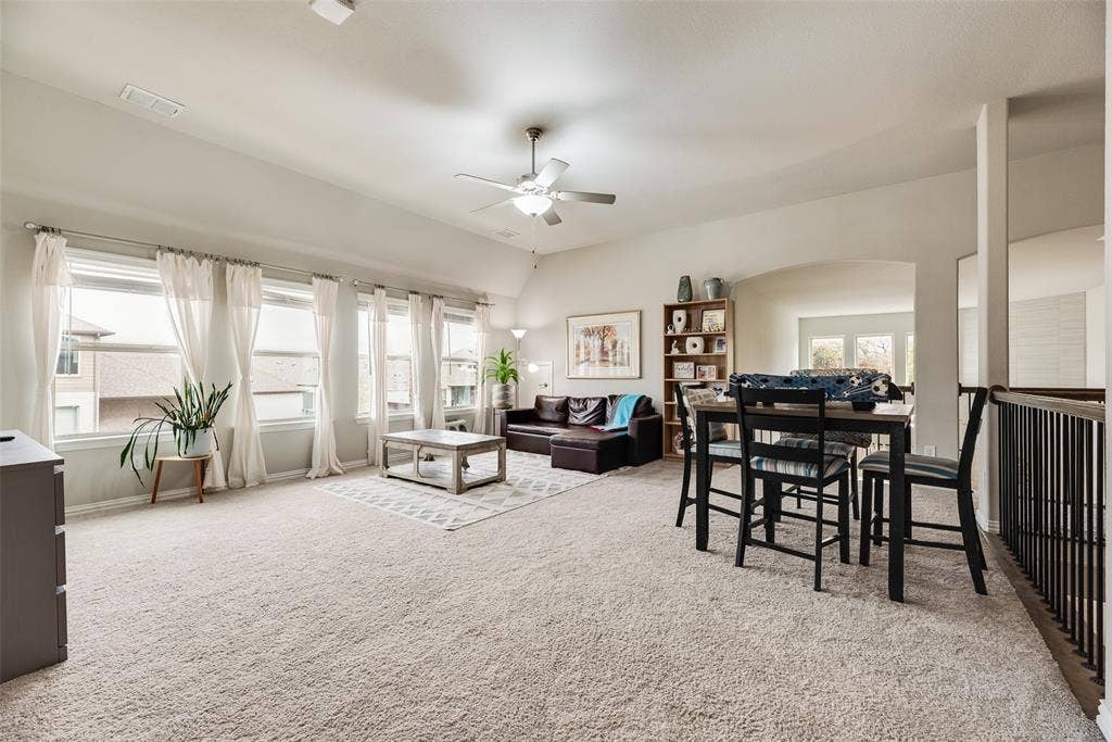 718 Waterbrook Parkway, Argyle, TX 76226 Vaulted ceiling, multiple windows with white trim, recessed lighting, ceiling fan, and arched entryway