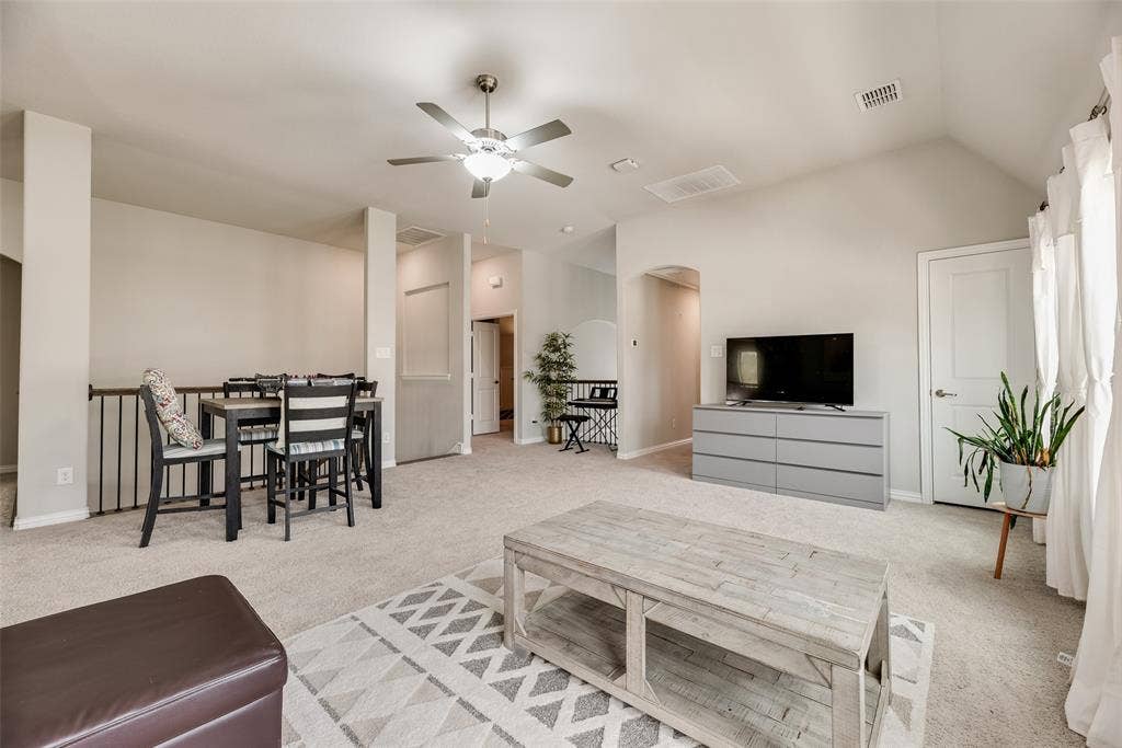 718 Waterbrook Parkway, Argyle, TX 76226 Carpeted flooring, vaulted ceiling, ceiling fan with integrated lighting, and white interior doors with brushed nickel hardware
