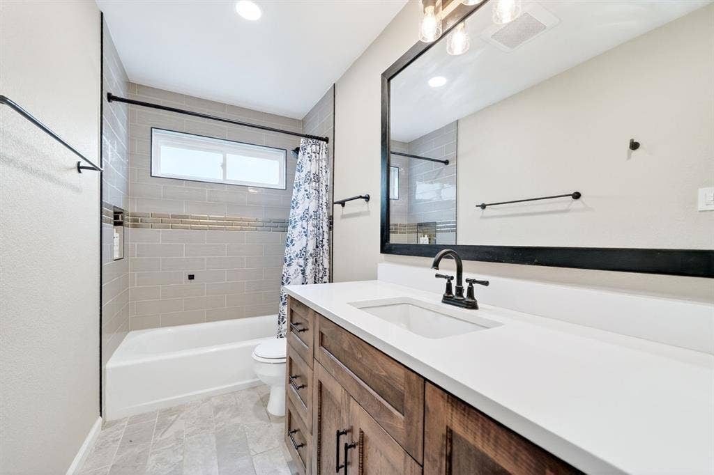 Wood-finish vanity with a white countertop and rectangular sink