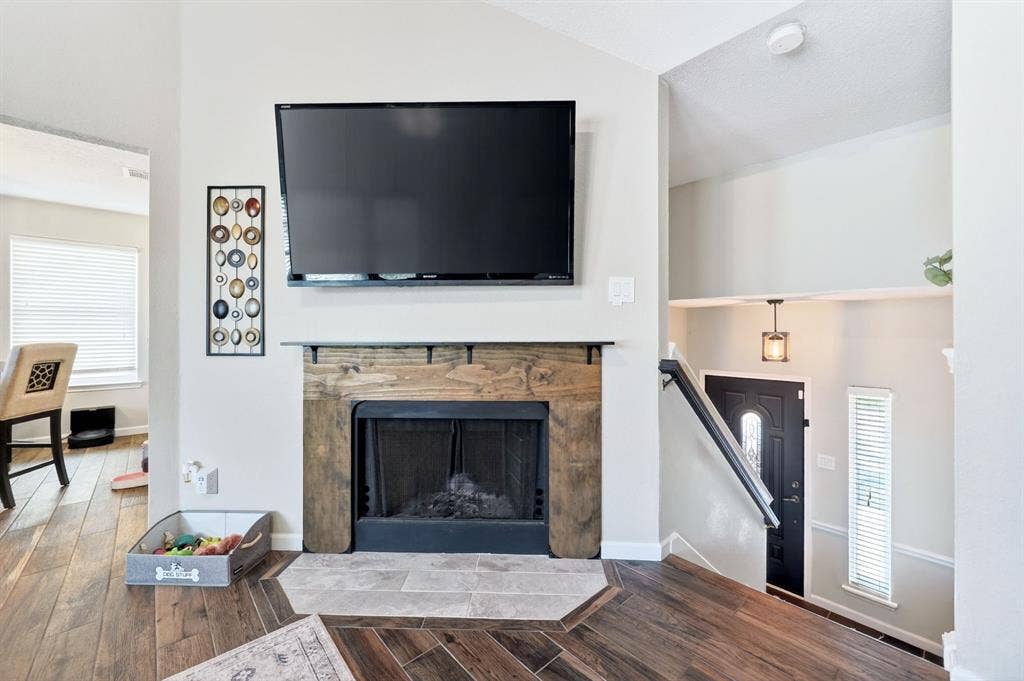 Fireplace with a wood-finish mantel and tile hearth