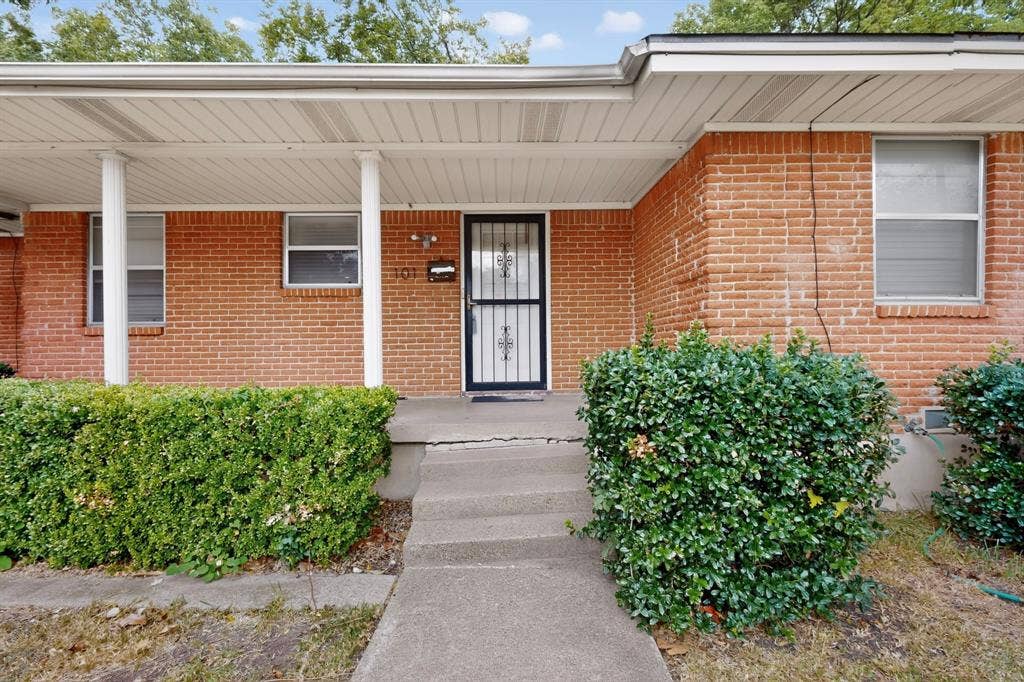 101 Spinner Circle, DeSoto, TX 75115 Brick exterior with covered front entry and concrete walkway