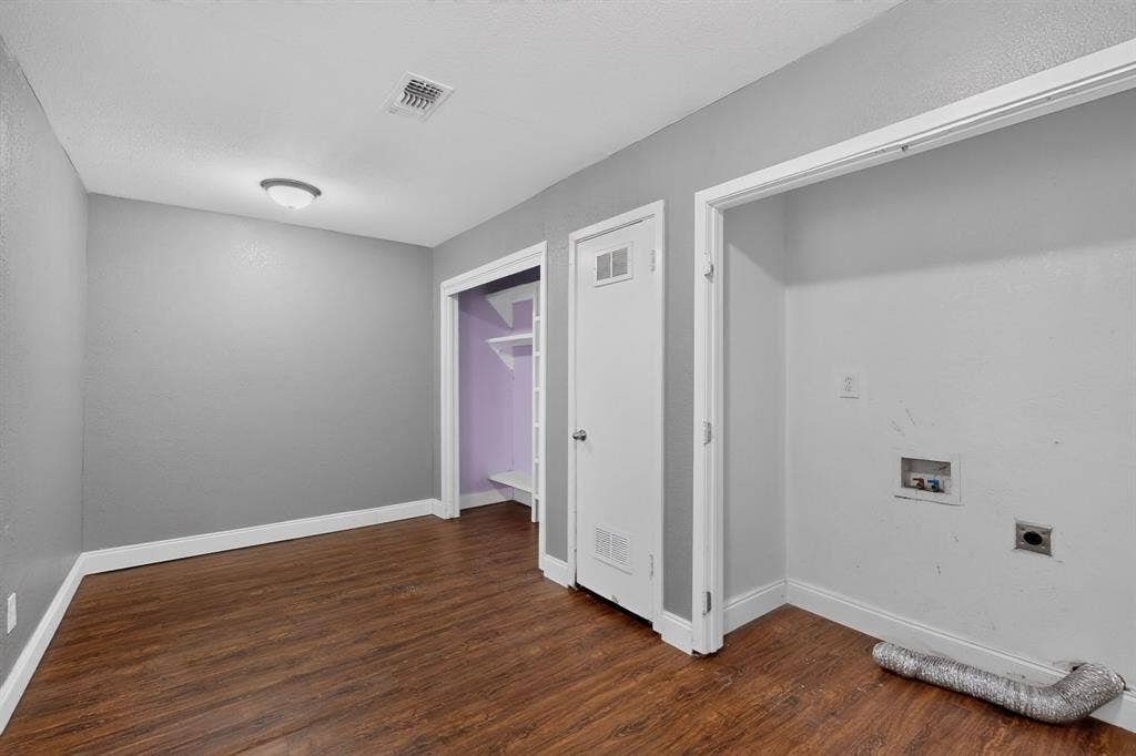 101 Spinner Circle, DeSoto, TX 75115 Wood-finish flooring, light grey wall paint, flush mount ceiling fixture, and a built-in closet with shelving