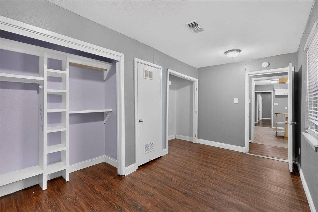 101 Spinner Circle, DeSoto, TX 75115 Wood-finish flooring, built-in open shelving, interior white doors, and a ceiling-mounted light fixture
