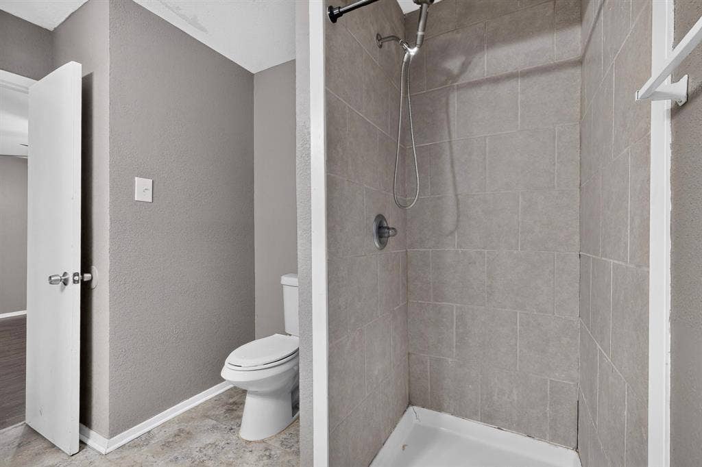 101 Spinner Circle, DeSoto, TX 75115 Tiled shower stall with a white base and a chrome shower head
