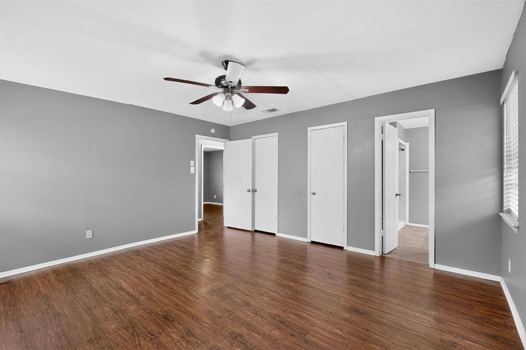 101 Spinner Circle, DeSoto, TX 75115 Wood-finish flooring, ceiling fan with light fixture, and multiple white doors