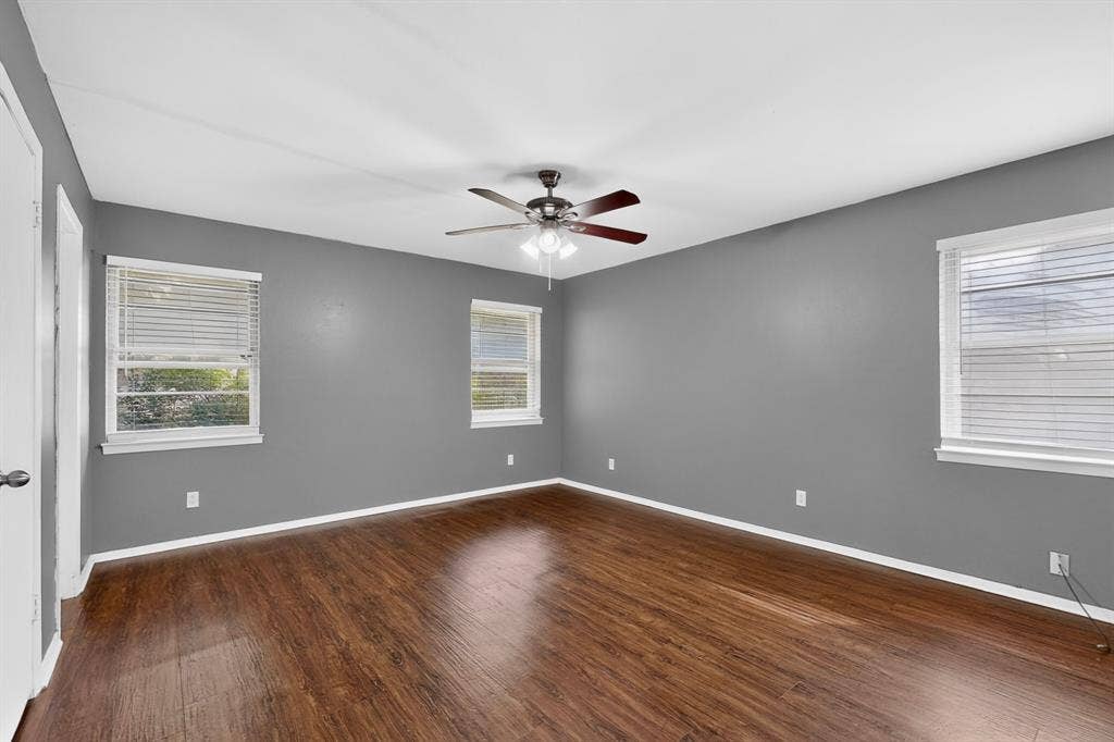 101 Spinner Circle, DeSoto, TX 75115 Wood-finish flooring, multiple windows with blinds, ceiling fan, and painted walls