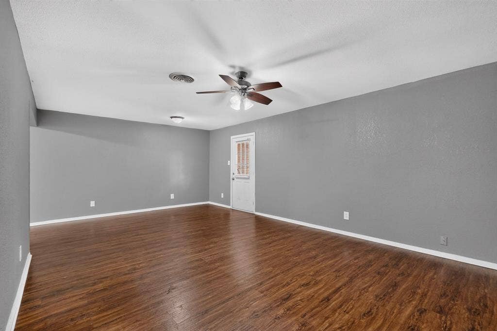 101 Spinner Circle, DeSoto, TX 75115 Spacious room with wood-finish flooring, light gray walls, and a white ceiling