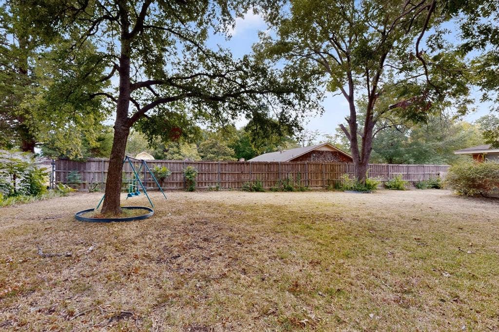 101 Spinner Circle, DeSoto, TX 75115 Expansive backyard with a full privacy fence and mature trees